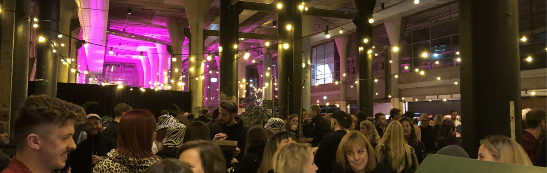 Crowd under string lights at the DEPT Weekender