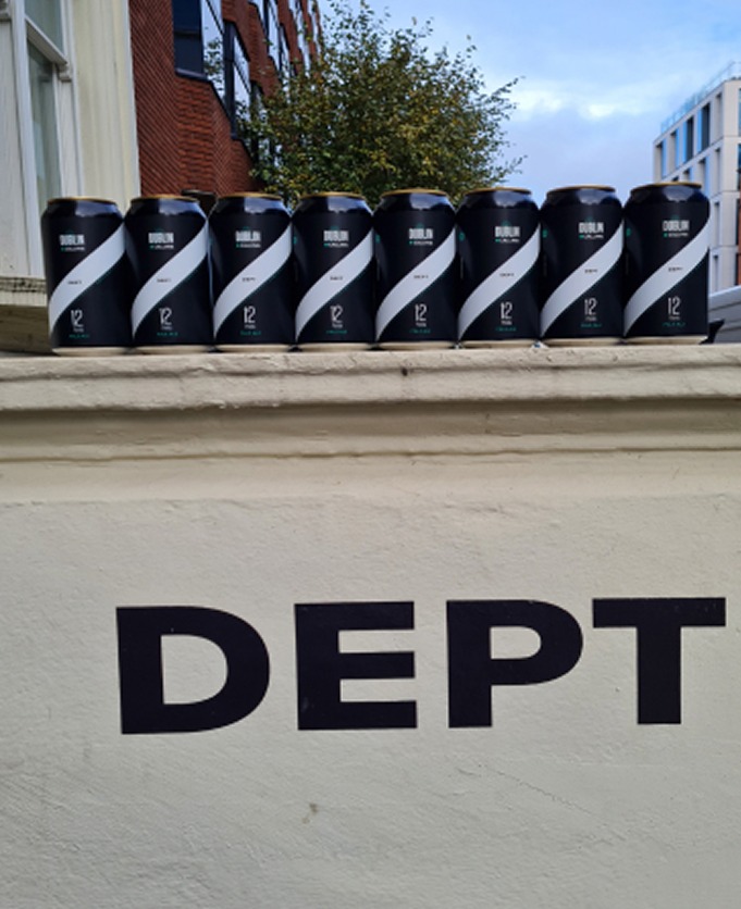 Cans lined up on the DEPT sign