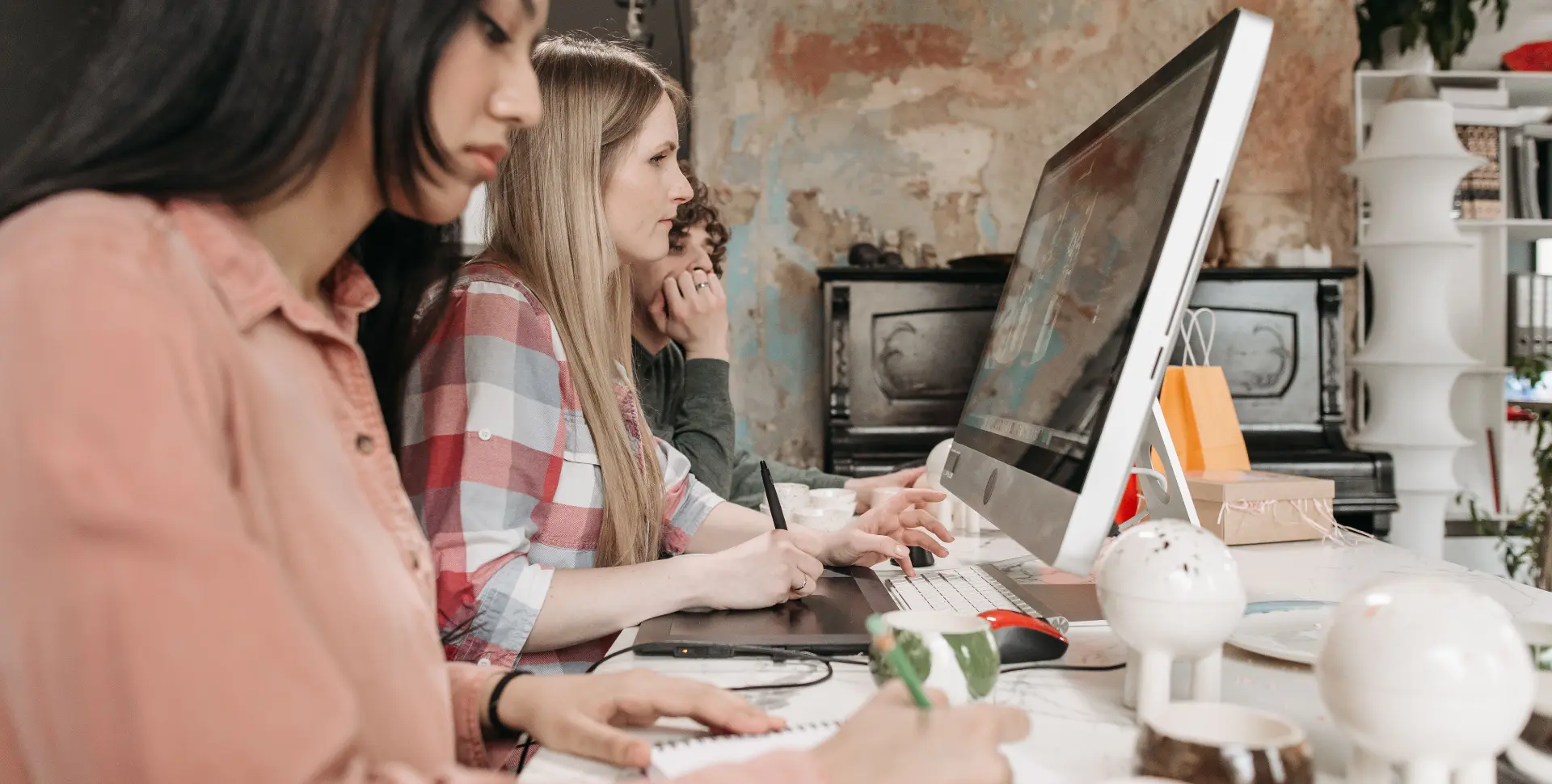 Designers and developers working together at one desk
